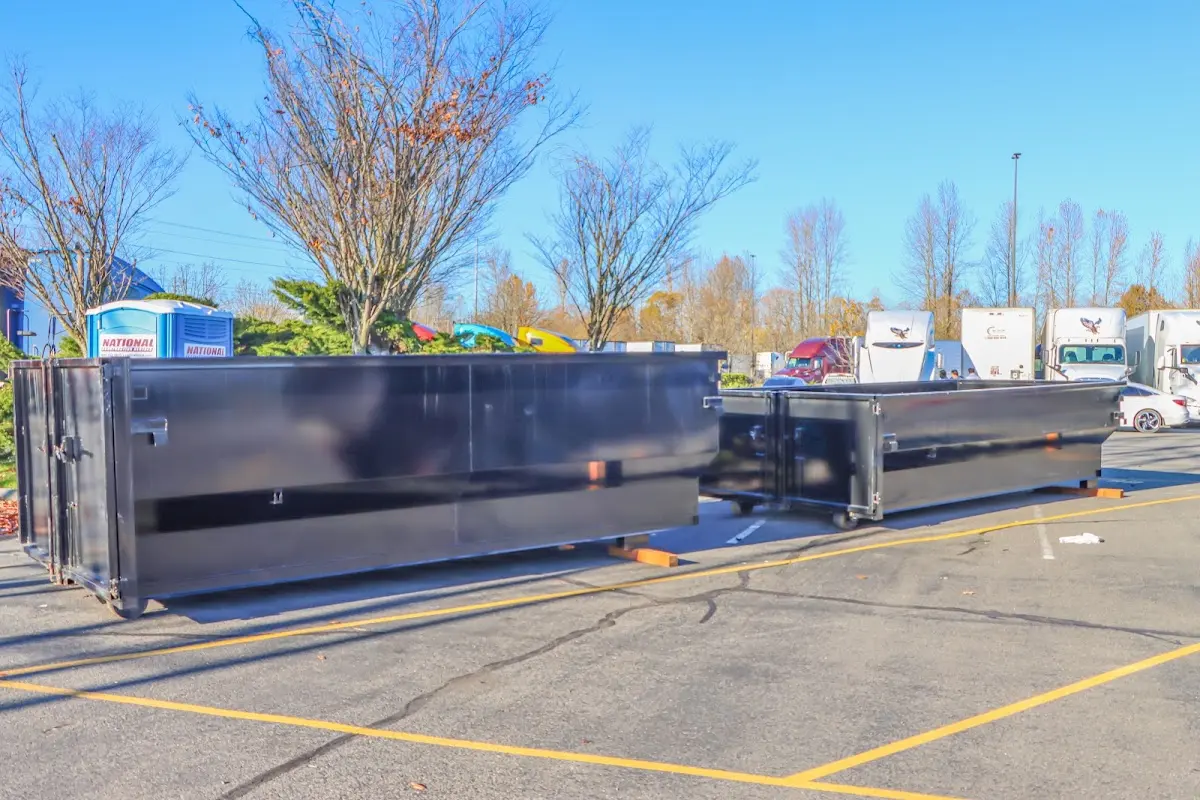 Professional dumpster rental service with roll-off container on residential driveway in Glasgow